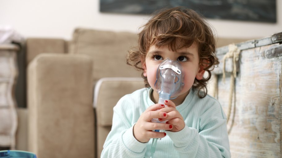 Little girl wearing a breathing mask